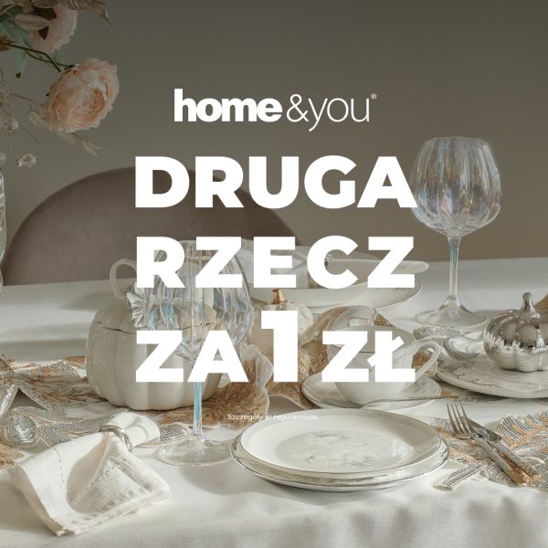 Grafika promocyjna marki home&you przedstawiająca elegancko nakryty stół z białą zastawą stołową, ozdobnym bieżnikiem, ozdobną ceramiką w kształcie dyni, kieliszkami do wina oraz sztućcami. Na środku widnieje duży, biały napis „DRUGA RZECZ ZA 1 ZŁ”, a nad nim znajduje się logo marki home&you. U dołu umieszczono drobną informację „Szczegóły w regulaminie.”.