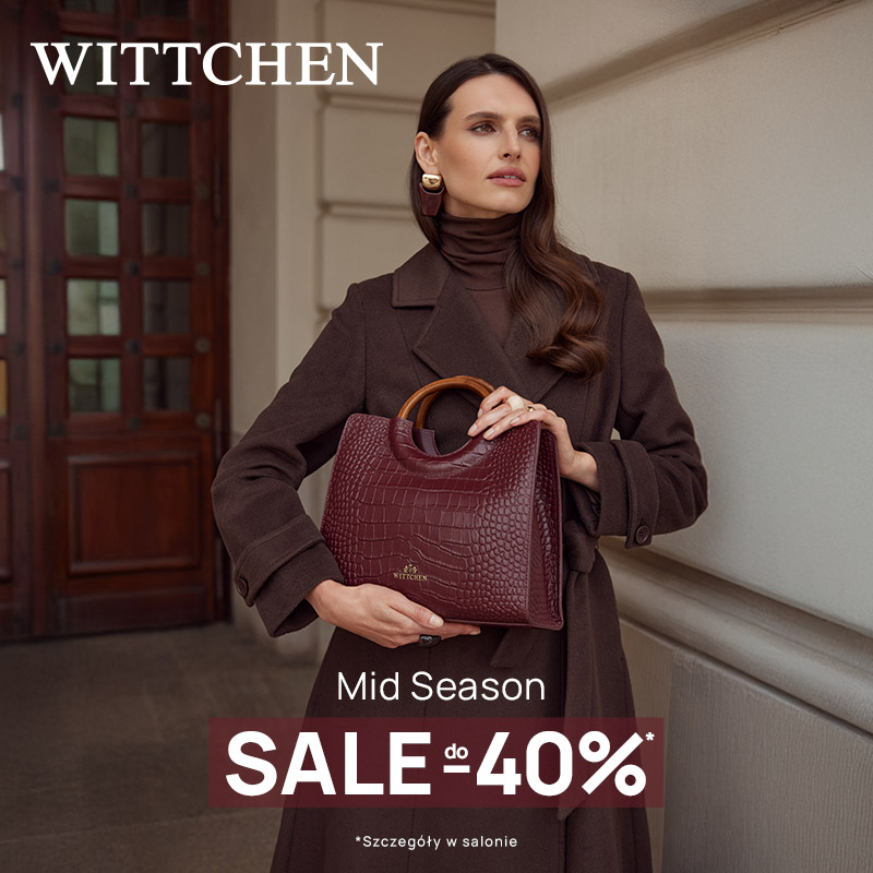 Brunetka w brązowym płaszczu i golfie trzymająca bordową torebkę z tłoczeniem w krokodyla i drewnianymi uchwytami, na tle kamienicy, z napisem „Mid Season Sale do -40%”
